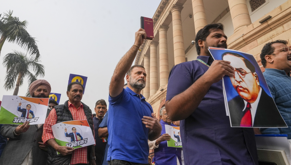 When the I.N.D.I.A. bloc protests at the Parliament complex in New Delhi, Congress MPs hold signs.