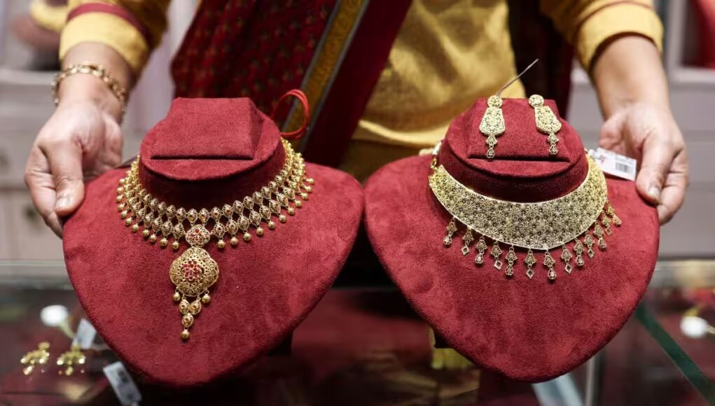 Gold climbs to three-month high as weaker dollar, Fed signals lift bullion
